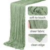 A vertical drape of sage green semi-sheer gauze fabric showing soft texture and clean edge.