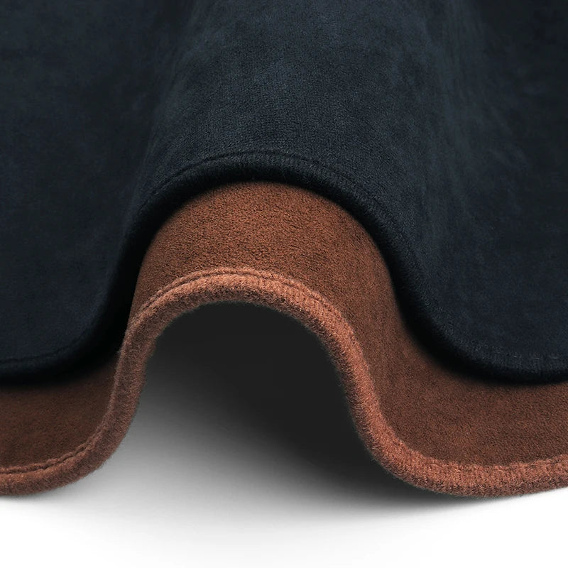 A custom fit dashboard sun shield in black fabric with a brown trim, shown from the underside.
