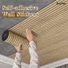 A hand is applying self-adhesive wood grain wall stickers onto a gray wall surface.
