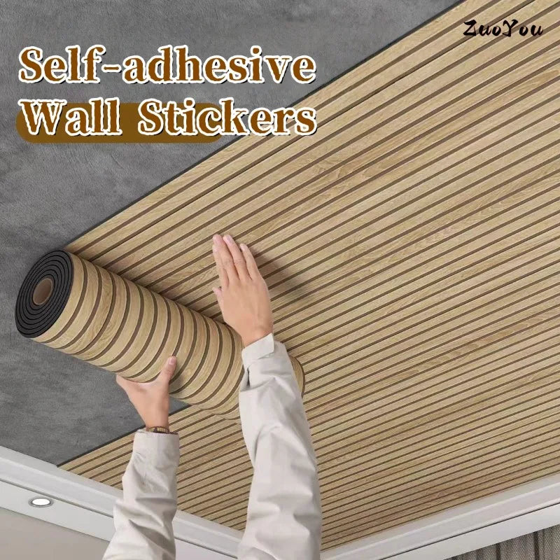 A hand is applying self-adhesive wood grain wall stickers onto a gray wall surface.
