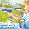 A child is firing a blue electric water gun at a water surface outdoors, with additional guns and water toys visible.
