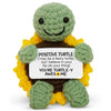 Handmade crochet turtle doll in green and yellow with an inspirational card