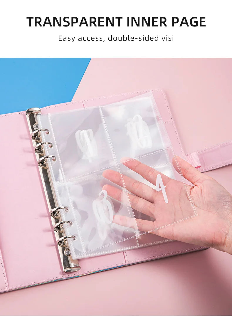 A hand holds an A5 budget binder with transparent inner pages and cash envelopes.