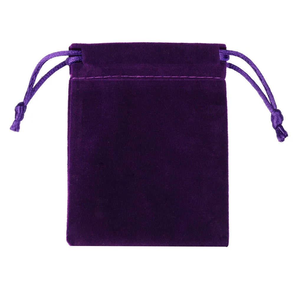 A deep purple velvet drawstring jewelry pouch with purple ties.