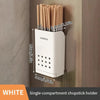 A white single-compartment chopstick holder with 10 bamboo chopsticks visible on a wooden surface.