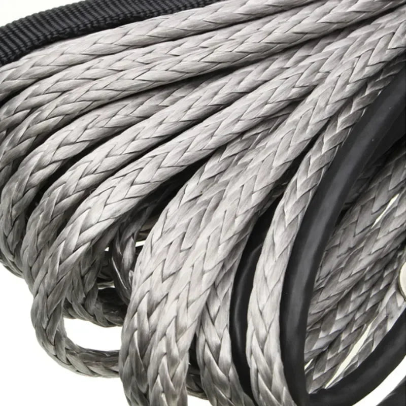Close-up of a thick gray braided synthetic winch rope coiled within a black protective sheath.