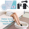 A person relaxing in a bathtub using an ionic foot spa machine with vibration massage attachments.