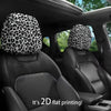 Two black car headrest covers with leopard print fabric are shown inside a vehicle.