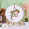 Embroidery starter kit featuring pre-printed floral and cat designs on white fabric