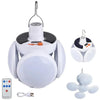 A white foldable solar camping lantern with a charging mechanism and remote control device.