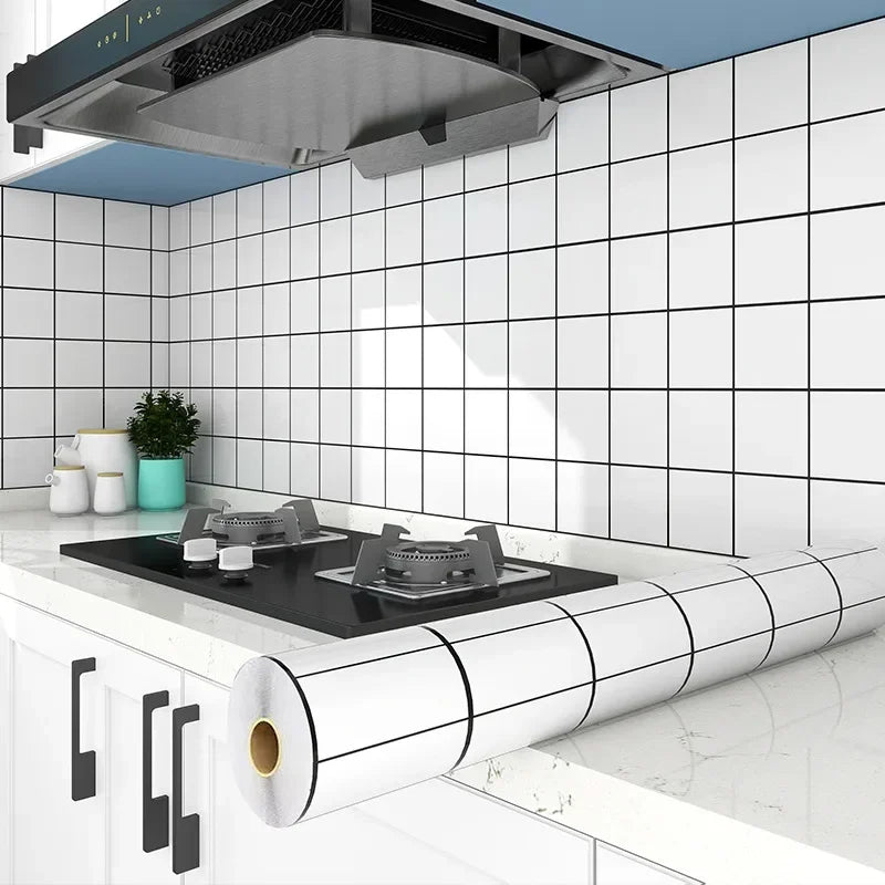 A kitchen splashback featuring white subway tiles, a stainless steel hood, and a roll of self-adhesive backsplash sticker.