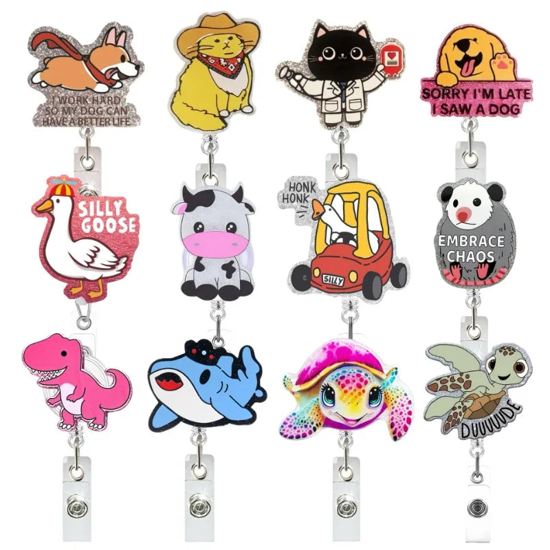 A set of glitter acrylic badge reels featuring various animal characters like a fox, cat, and dog.