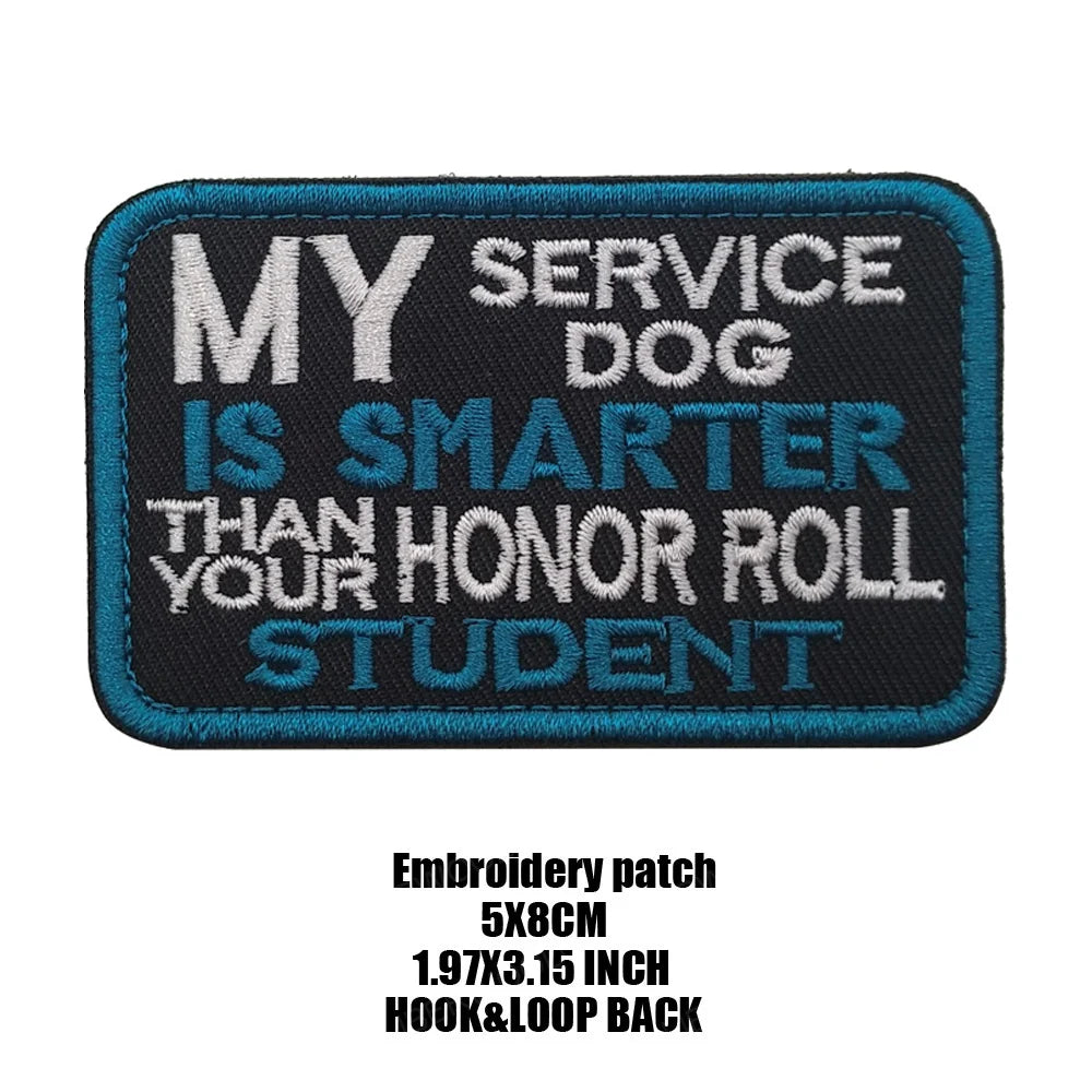 A dark blue embroidered patch with white text that reads MY SERVICE DOG IS SMARTER THAN YOUR HONOR ROLL STUDENT
