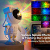 A white astronaut projector displays various nebula effects and flashing star lights on a screen.