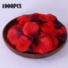 A pile of 1000 pieces of deep red and purple silk rose petals in a wooden bowl.