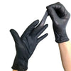 A hand wearing a black disposable nitrile glove is shown holding another gloved hand.