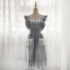 A gray ruffled cotton linen kitchen apron with lace trim displayed on a mannequin.