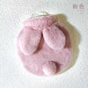A pink plush rabbit hot water bottle with a soft flannel cover.