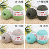 A set of fine yarn in various shades of green and gray, including solid and variegated colors, for knitting and crochet proje