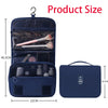 A dark blue travel makeup bag with a hanging hook, showing an open compartment containing makeup brushes and a separate zippe