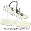 Large ivory white silicone faucet splash pad with a metal faucet and measuring lines.