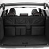 Interior view of a car trunk organizer with hanging storage pockets and padded compartments.