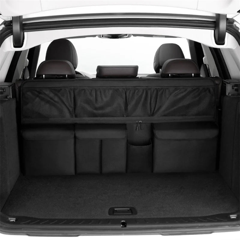 Interior view of a car trunk organizer with hanging storage pockets and padded compartments.