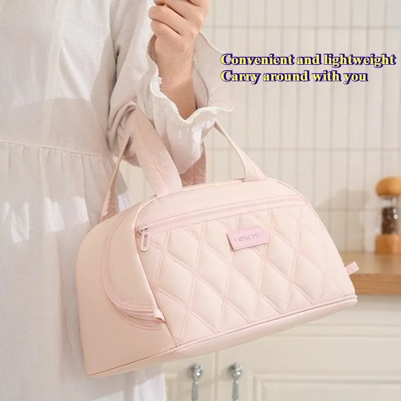 A light pink quilted PU leather insulated lunch tote bag being held by a person.
