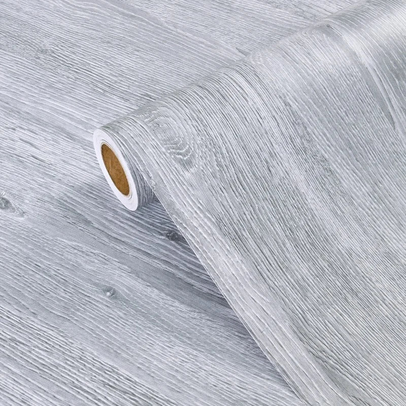 Roll of self-adhesive wood grain cabinet and furniture refacing film in light gray