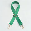 A green nylon bag strap with a gold buckle, shown in an 'X' shape.