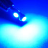 A close-up view of a T5 LED instrument panel bulb kit with twist lock bases illuminating a bright blue light.
