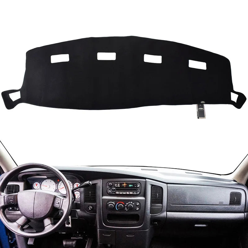 Black custom-fit dash cover for a Dodge Ram truck interior.