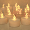 A close-up of a set of glowing LED tea lights with flickering flames arranged on a surface.