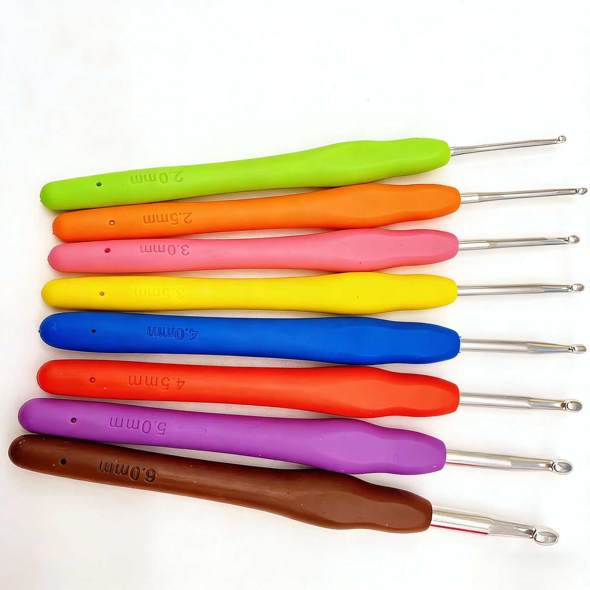 An arrangement of eight brightly colored crochet hooks and knitting needles in sizes ranging from 2mm to 6mm.