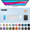 A computer monitor is displayed above a light blue desk pad featuring a keyboard, mouse, smartphone, and various colored circ
