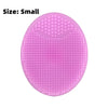 A small, pink silicone facial mask bowl with a textured surface and built-in tray.