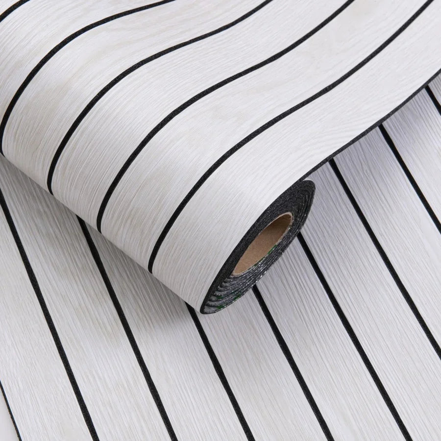 Roll of white wallpaper with black diagonal stripes, showing the texture and pattern.