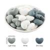 A bowl filled with ten silicone heart beads in light gray, white, and dim gray colors.