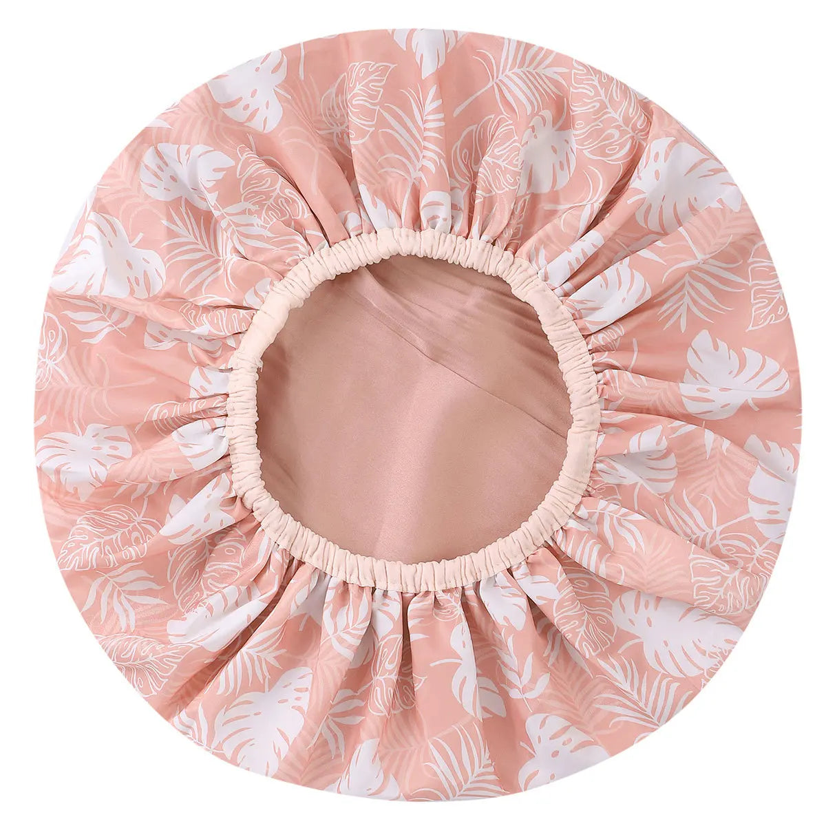A large pink and white floral patterned satin-lined waterproof shower cap for hair protection.