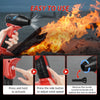 A hand is using a red cordless handheld jet blower to generate a strong stream of fire or smoke.