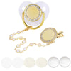 A sparkling rhinestone pacifier with a clip for babies shown next to several white silicone pacifiers.