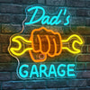 Blue and orange neon sign on a brick wall spelling out Dad's Garage