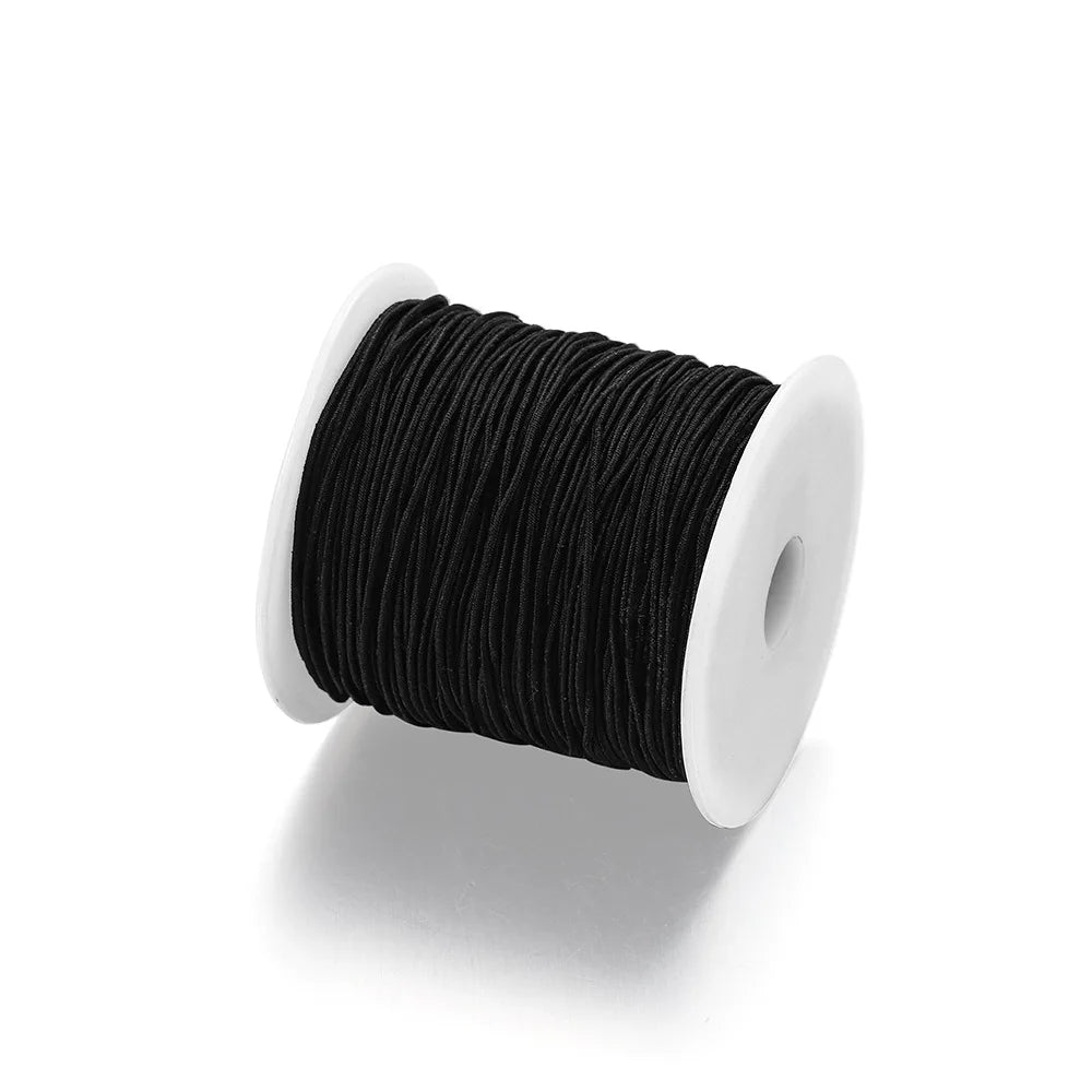 Black stretchy rainbow elastic cord wound on a white spool