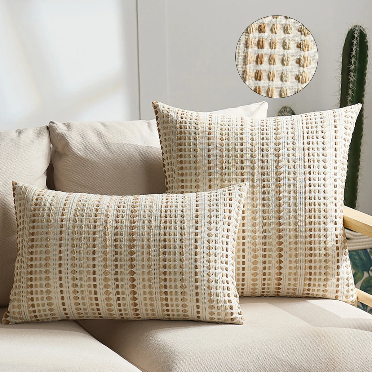 Two beige linen pillow covers with a textured pattern are displayed on a light sofa.