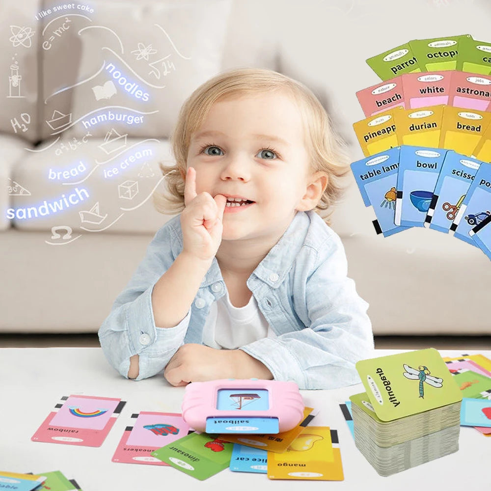 A toddler smiles while interacting with a set of colorful flash cards and learning toys.
