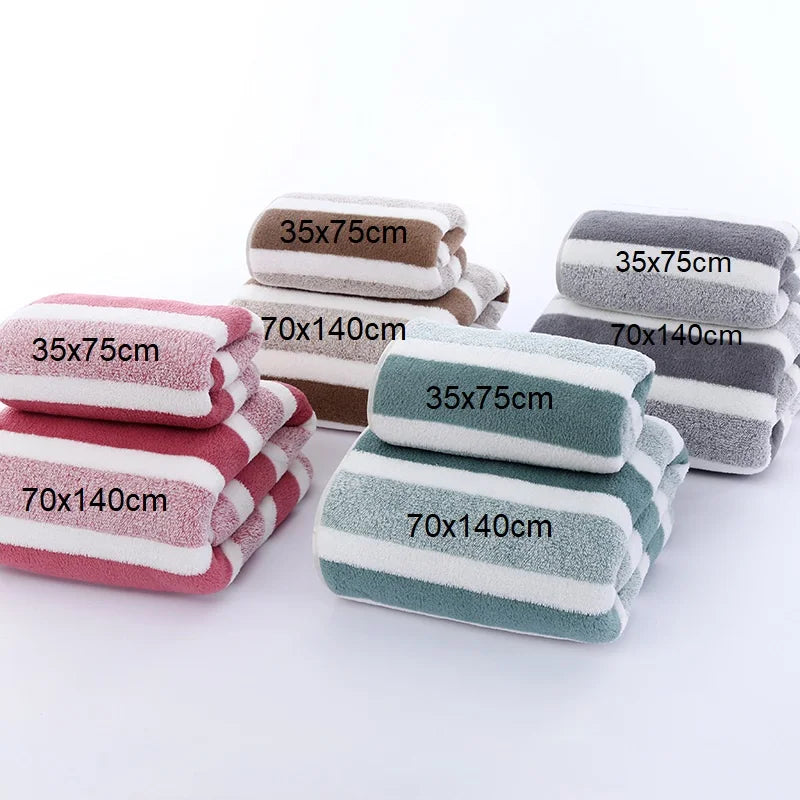 A set of striped microfiber towels in pink, gray, and green colors with various dimensions shown flat.