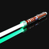 An RGB metal lightsaber with a glowing green blade and an orange hilt, displayed against a black background.