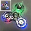 A clear LED glow fidget spinner with multiple colored lights and a magnified view of the mechanism.