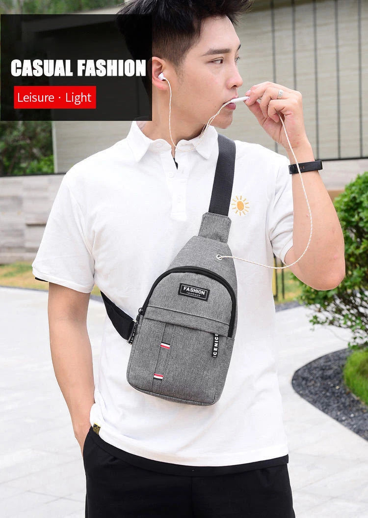 A young man wearing a white shirt and black pants is holding a gray fanny pack and using a straw to sip a drink.
