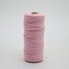 Pink macrame cord in a spool for crafting